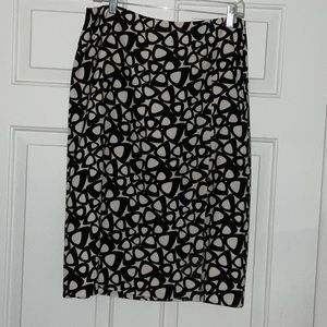 Black and white lined skirt with side zipper and slit in front size 10.